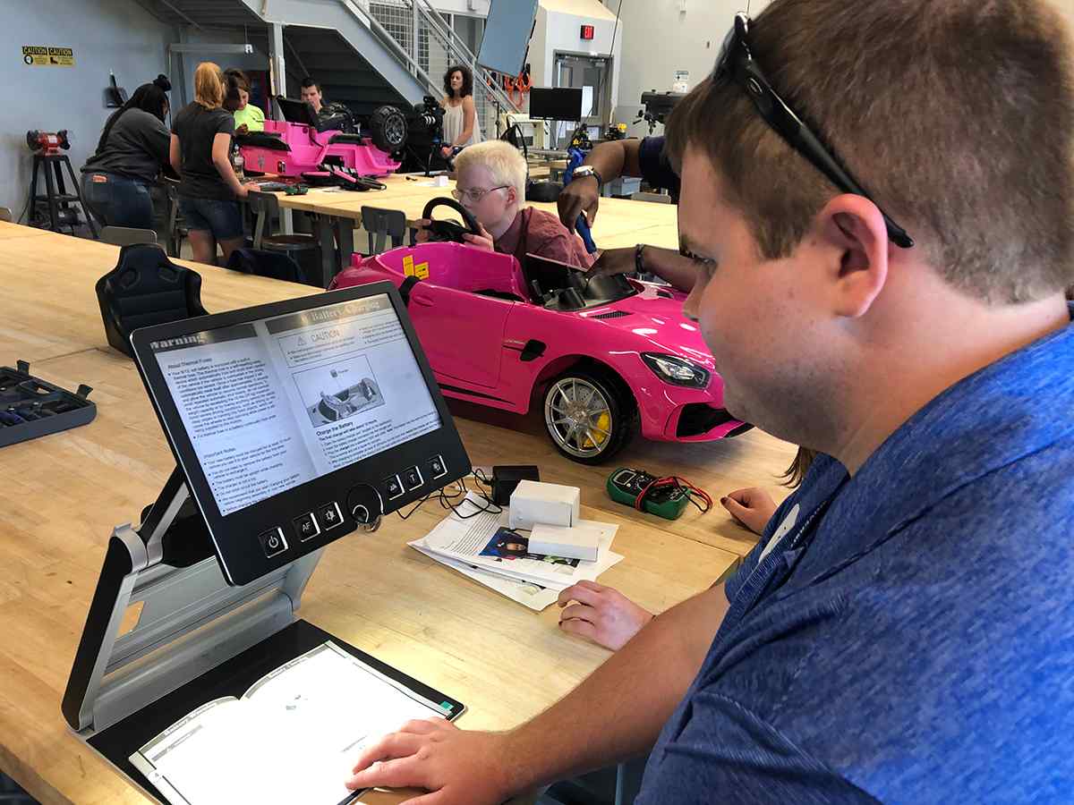 Students modify off-the-shelf toy cars for children with disabilities as part of the GoBabyGo program.