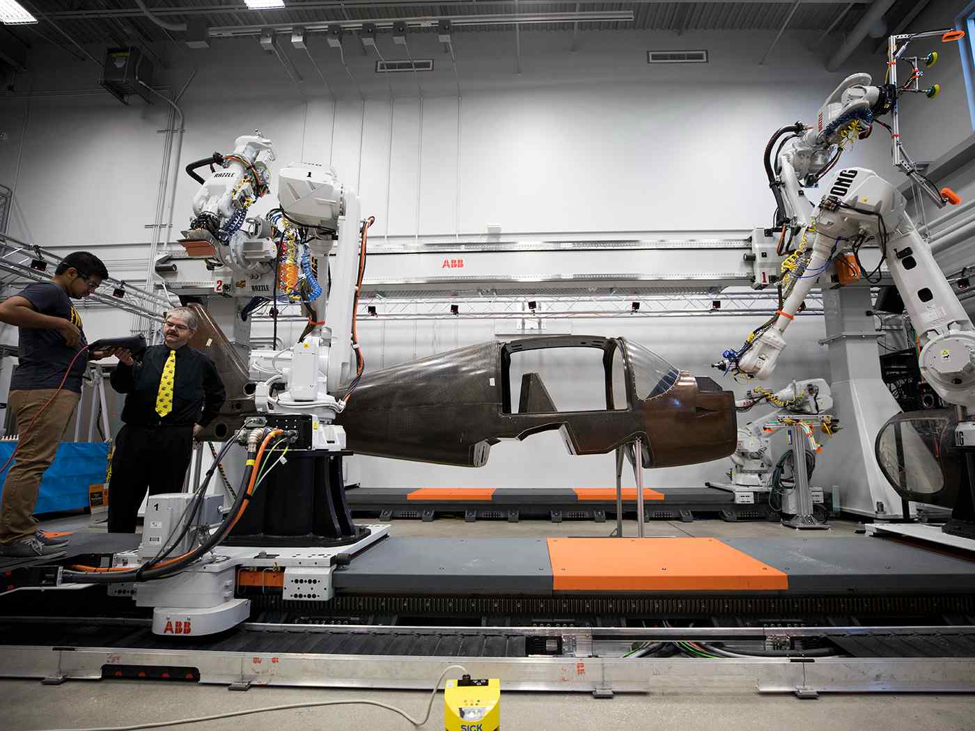 Students working on plane in Robotics lab.