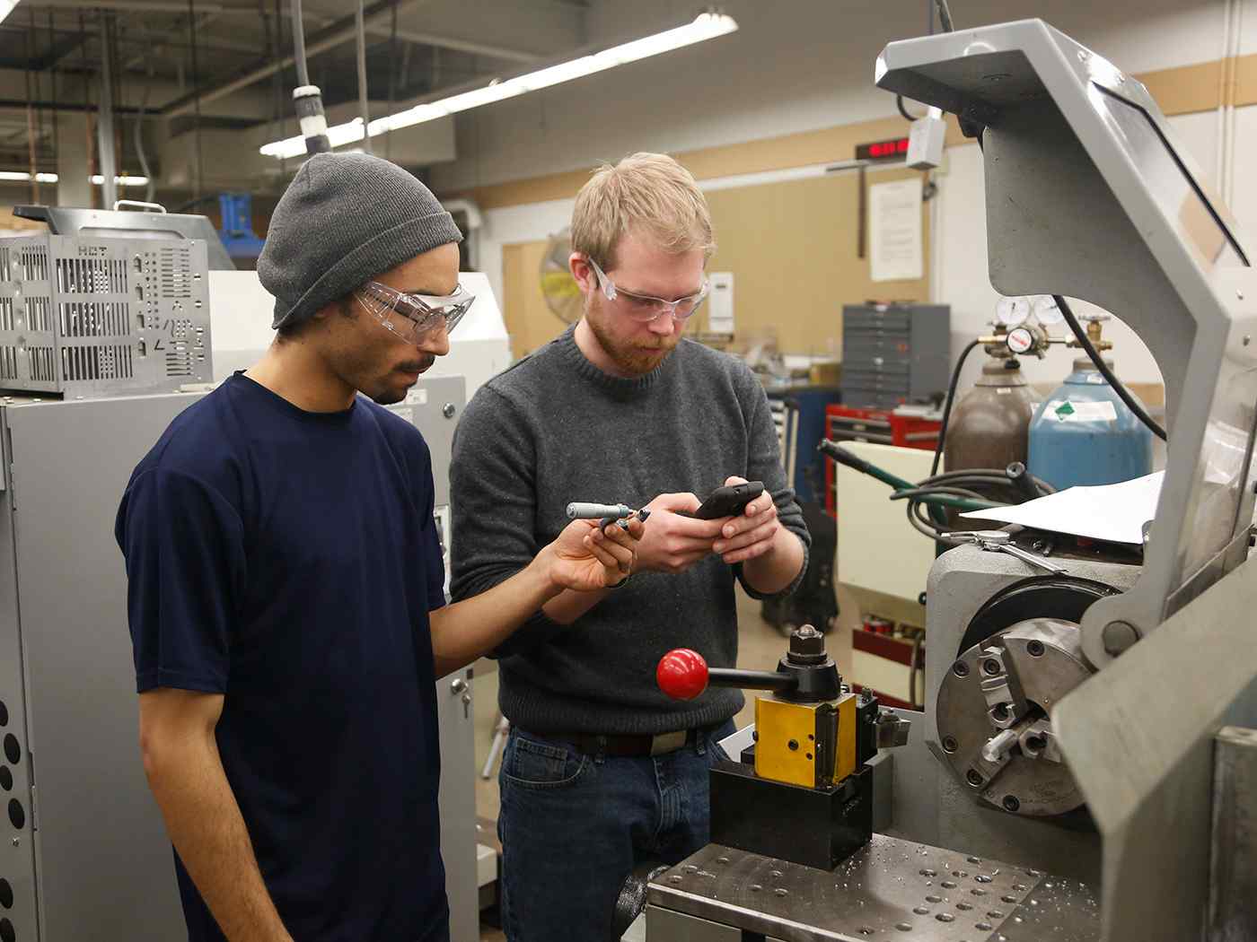 Mechanical engineering students working in lab.