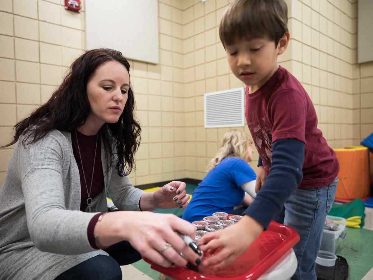 Female teacher working with kids.