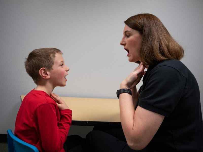 Student helping her patient with vocal exercises.