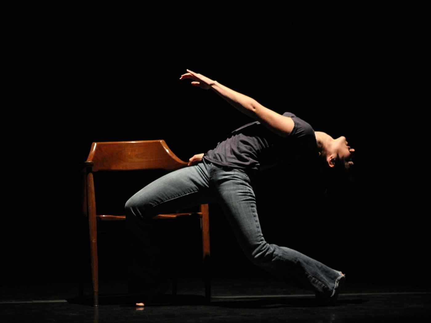 Female student dancing on stage.