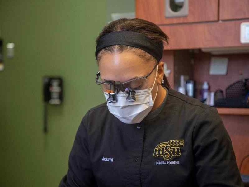 Dental Hygiene student cleaning teeth.