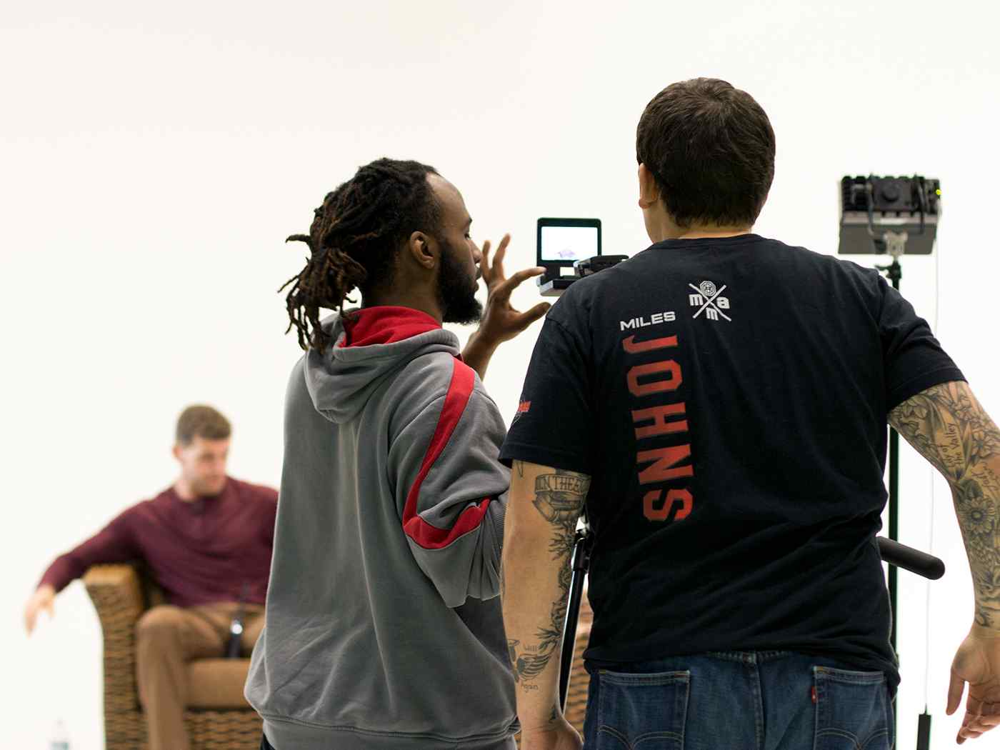 Filmmaking students in studio composing a shot.