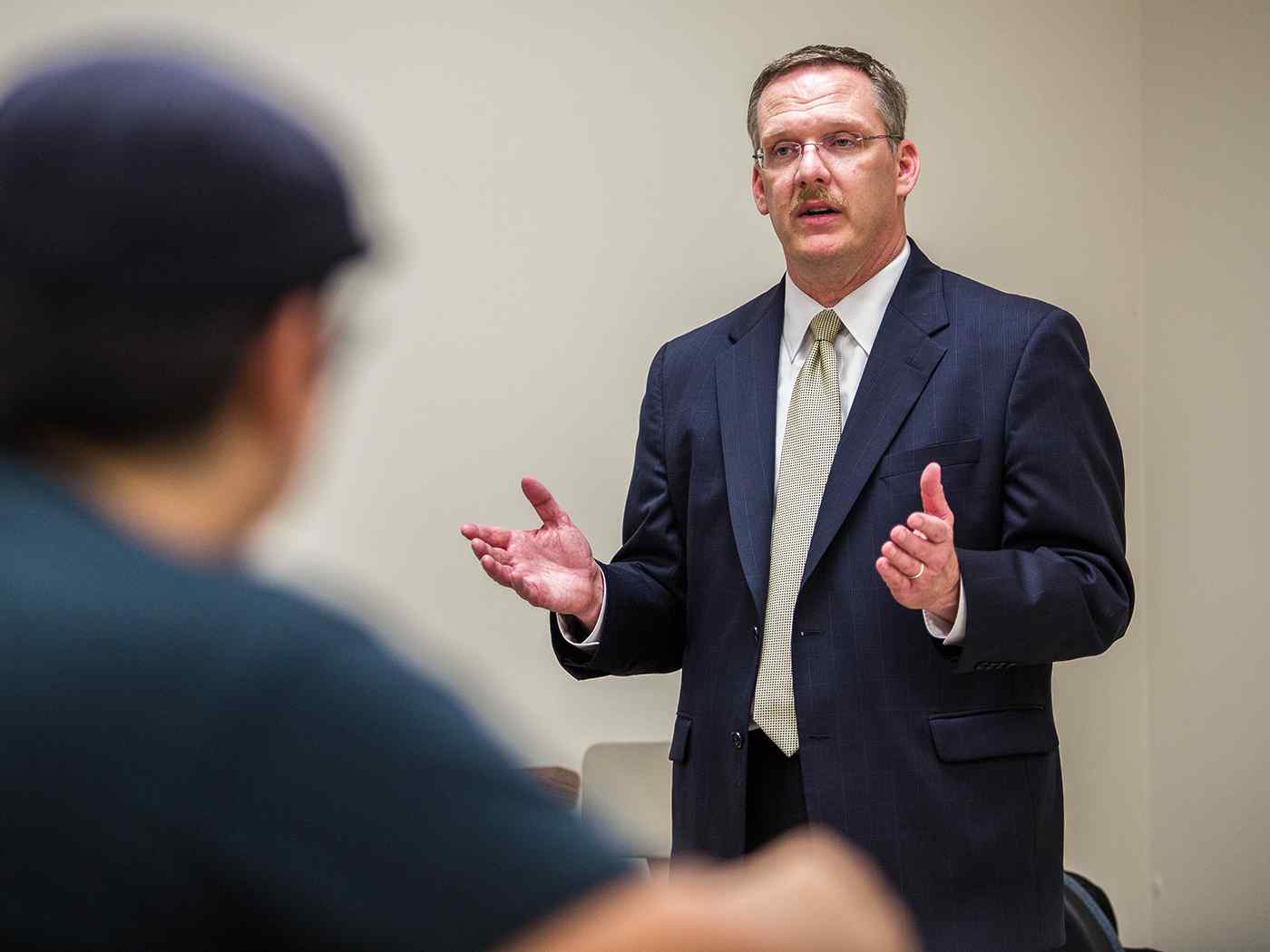 Professor teaching to his class.