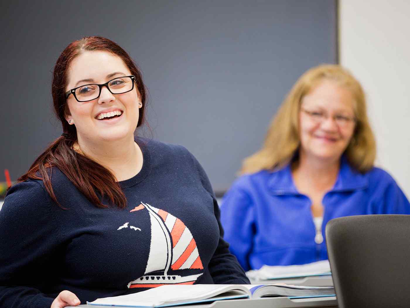 Two Communications students in the classroom.