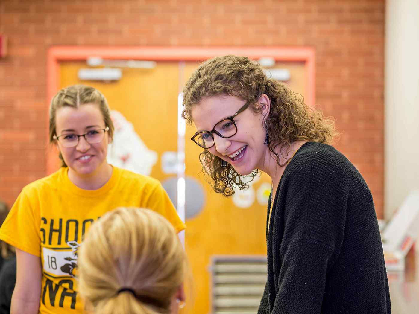 Two students talking to a professor