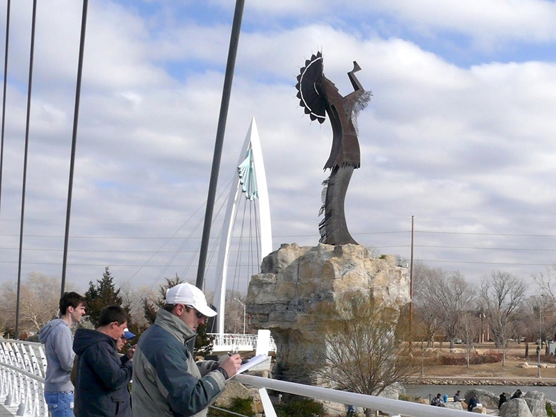 Students on location in Wichita by the Keeper of the Plains statue