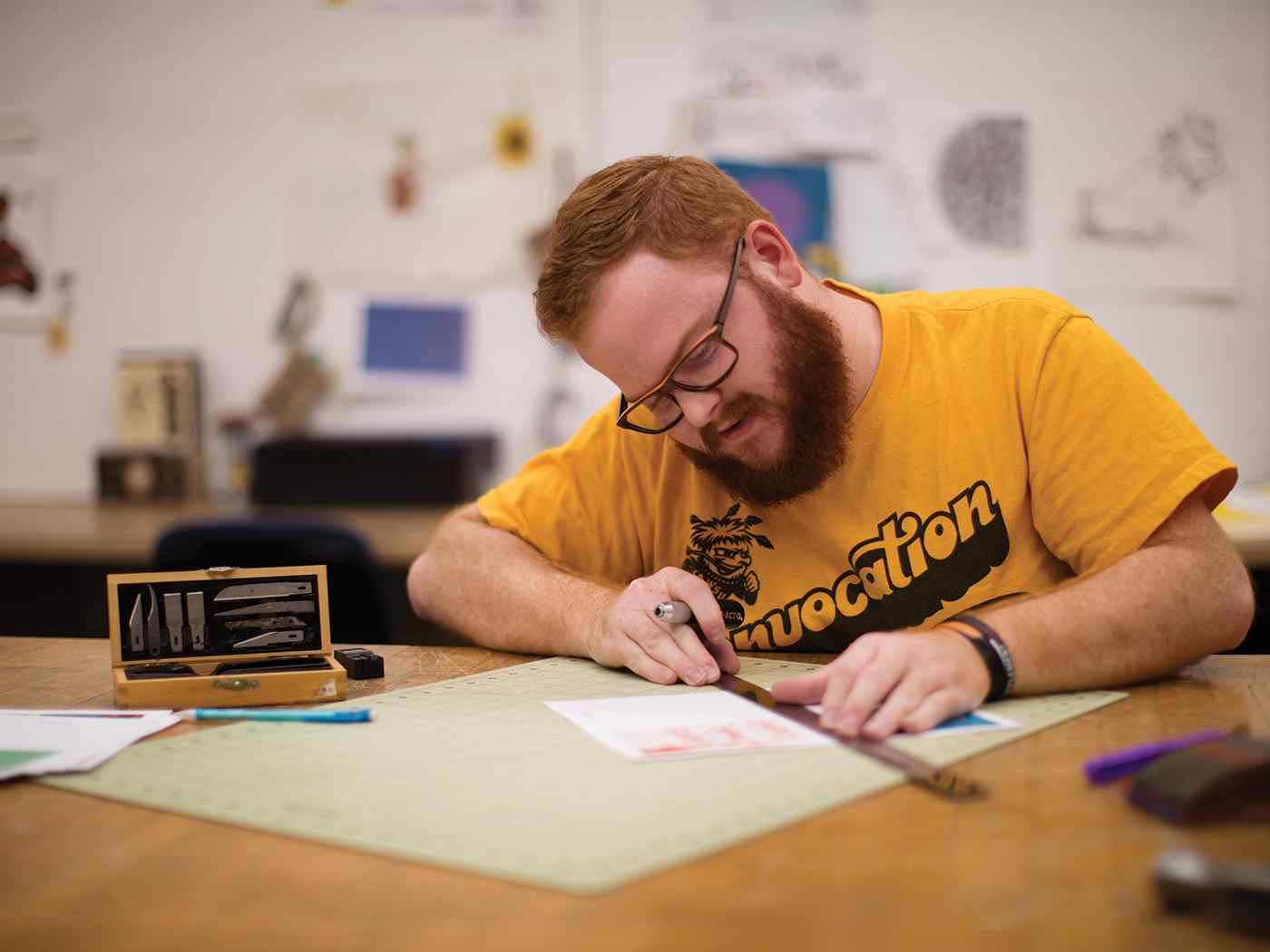 Male graphic design student in classroom.