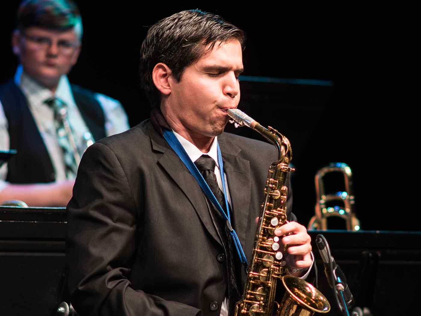 Male student playing instrument.