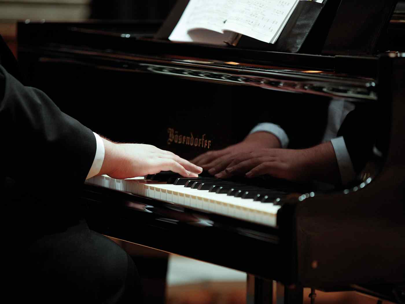 Student playing on the piano.