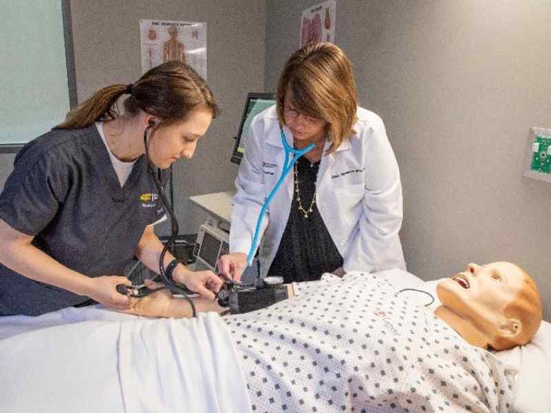 Student examining patient.