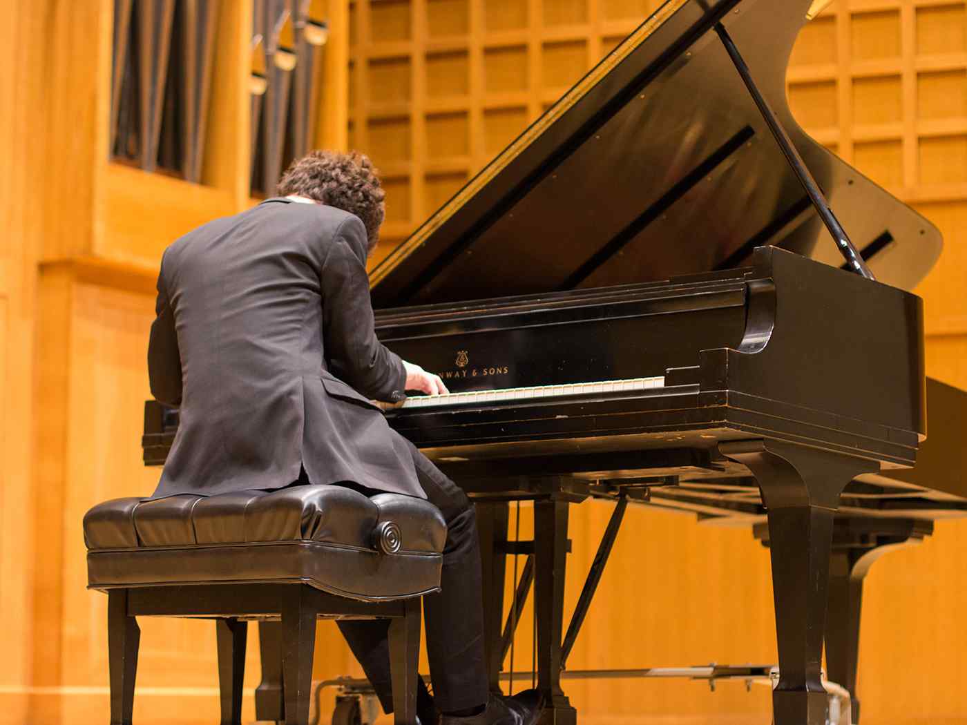 Male pianist plays in Wiedemann Hall