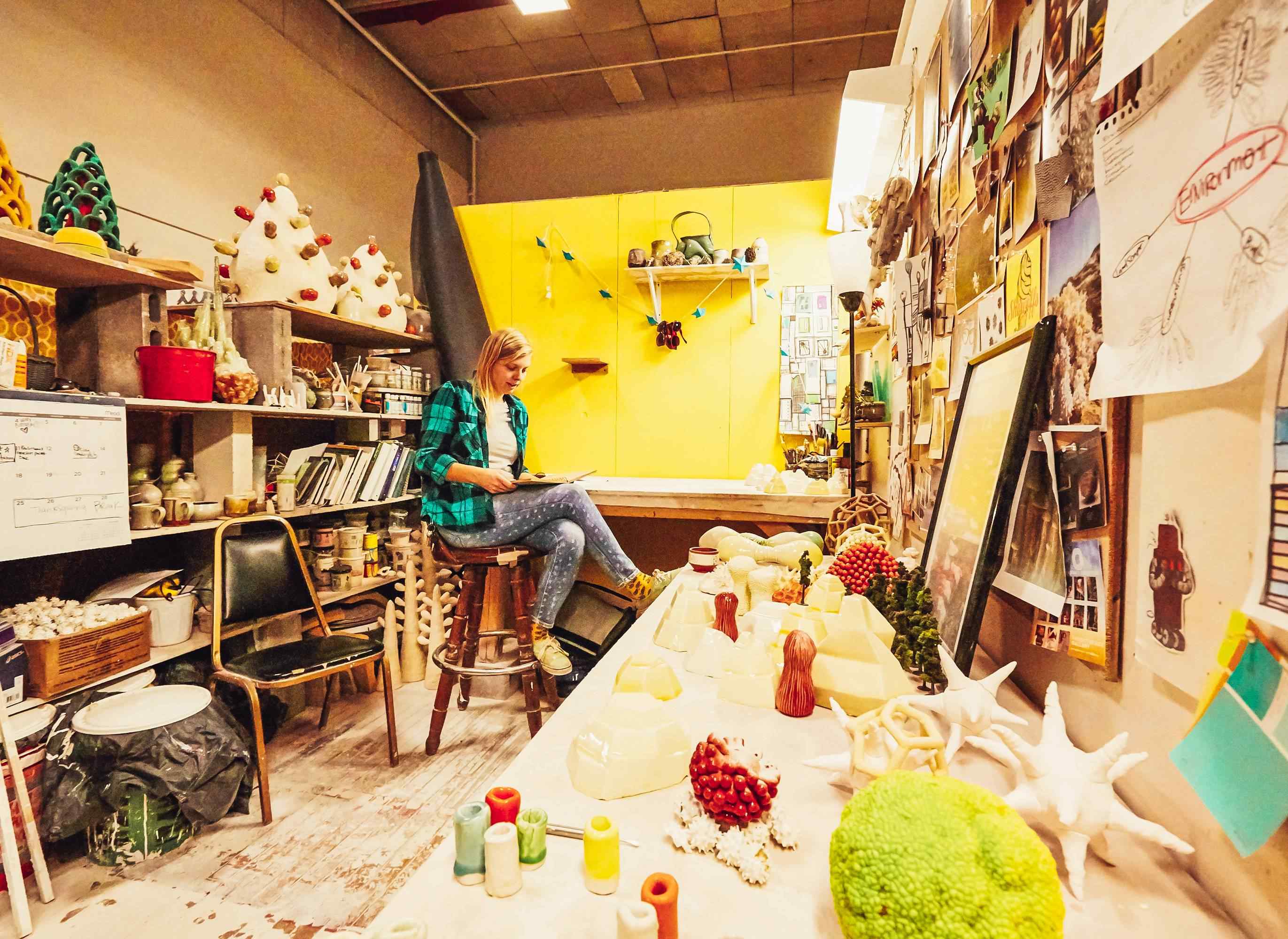 Female grad sculpture student in studio.