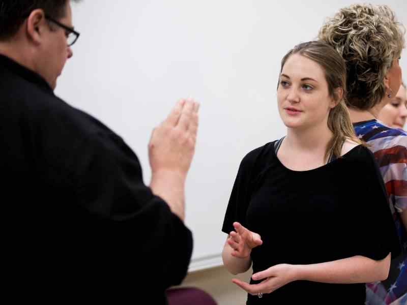 A student practices signing with an instructor in class