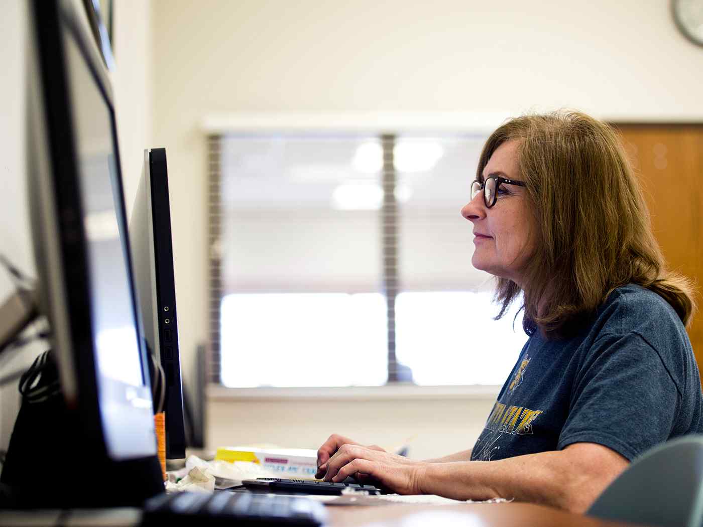 Adult learner on typing computer.