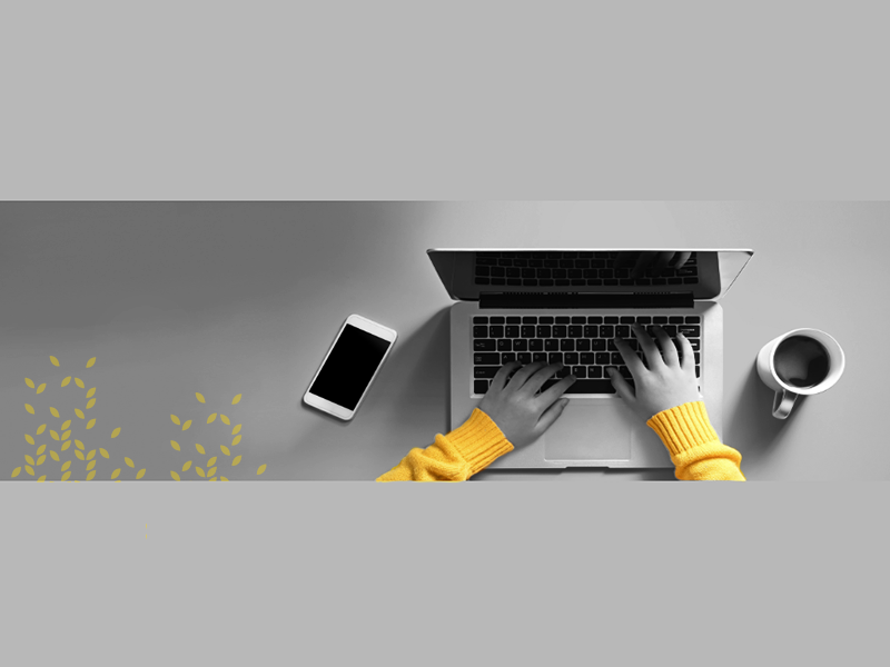 student at a desk typing on a laptop