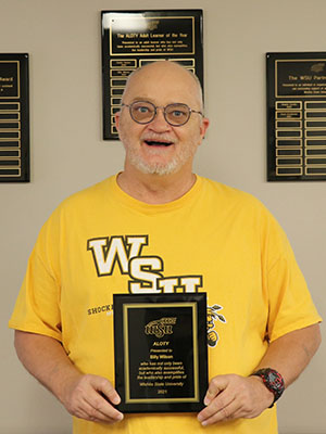 Image of student, Billy, Wilson, with award plaque. 