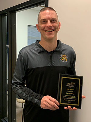 Image of Chad Steinkamp holding plaque