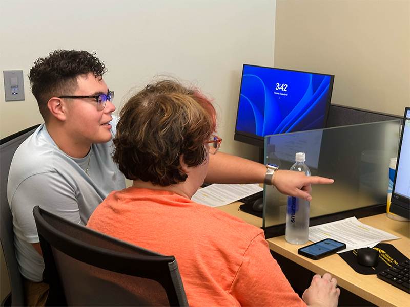 Marco talking with student