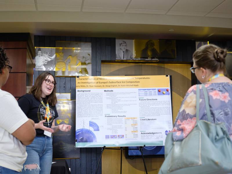 Student presenting research poster