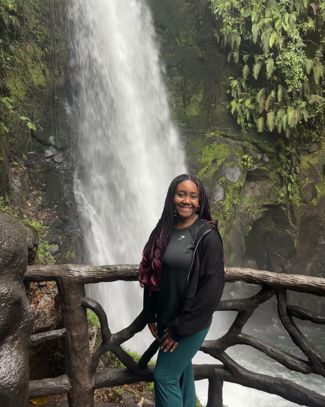 Alice in front of waterfall