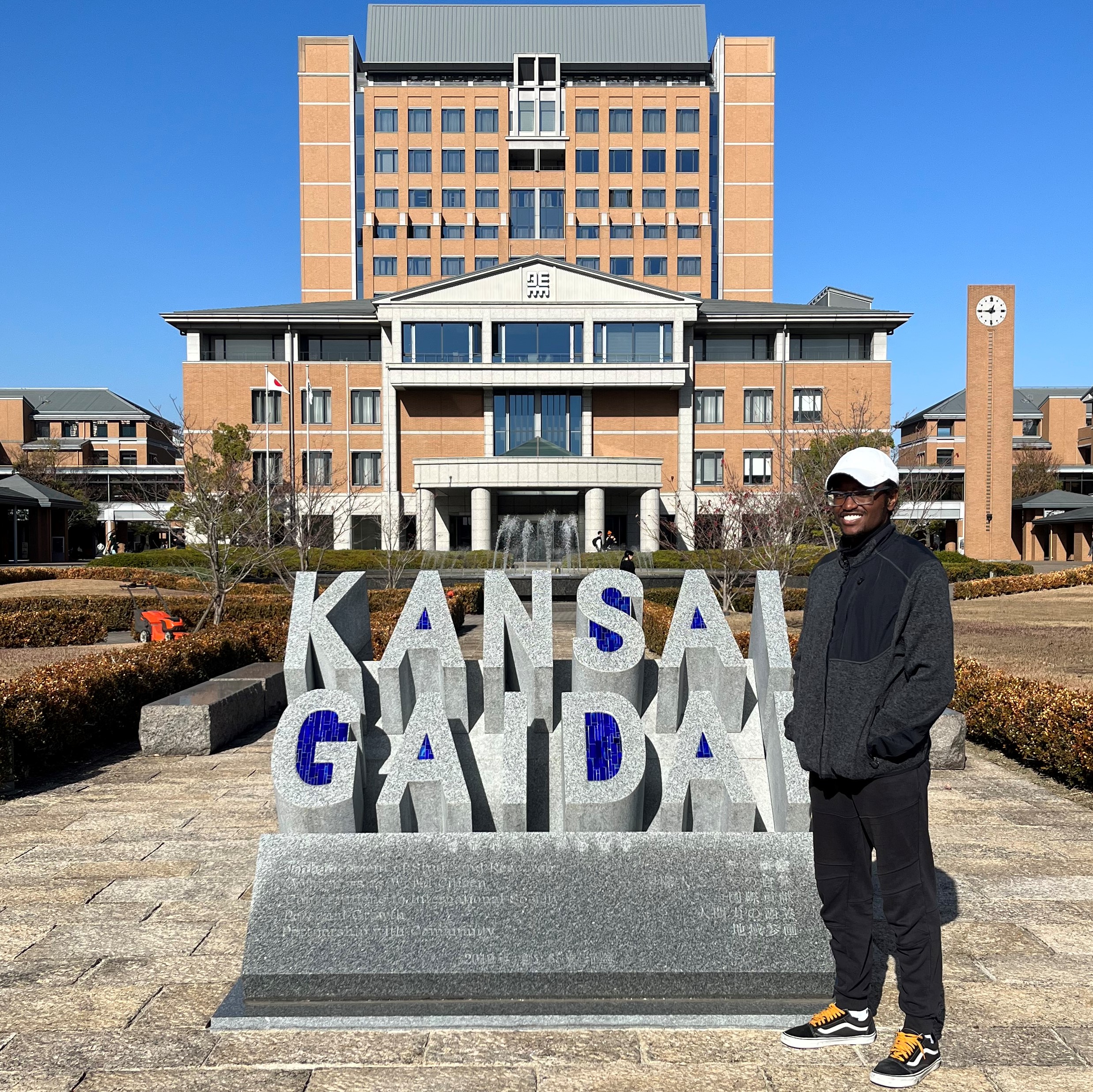 Student with KGU sign