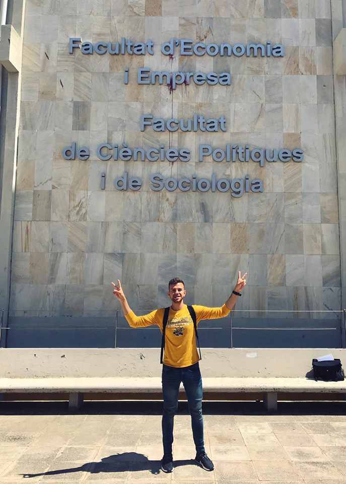 Samuel with university sign