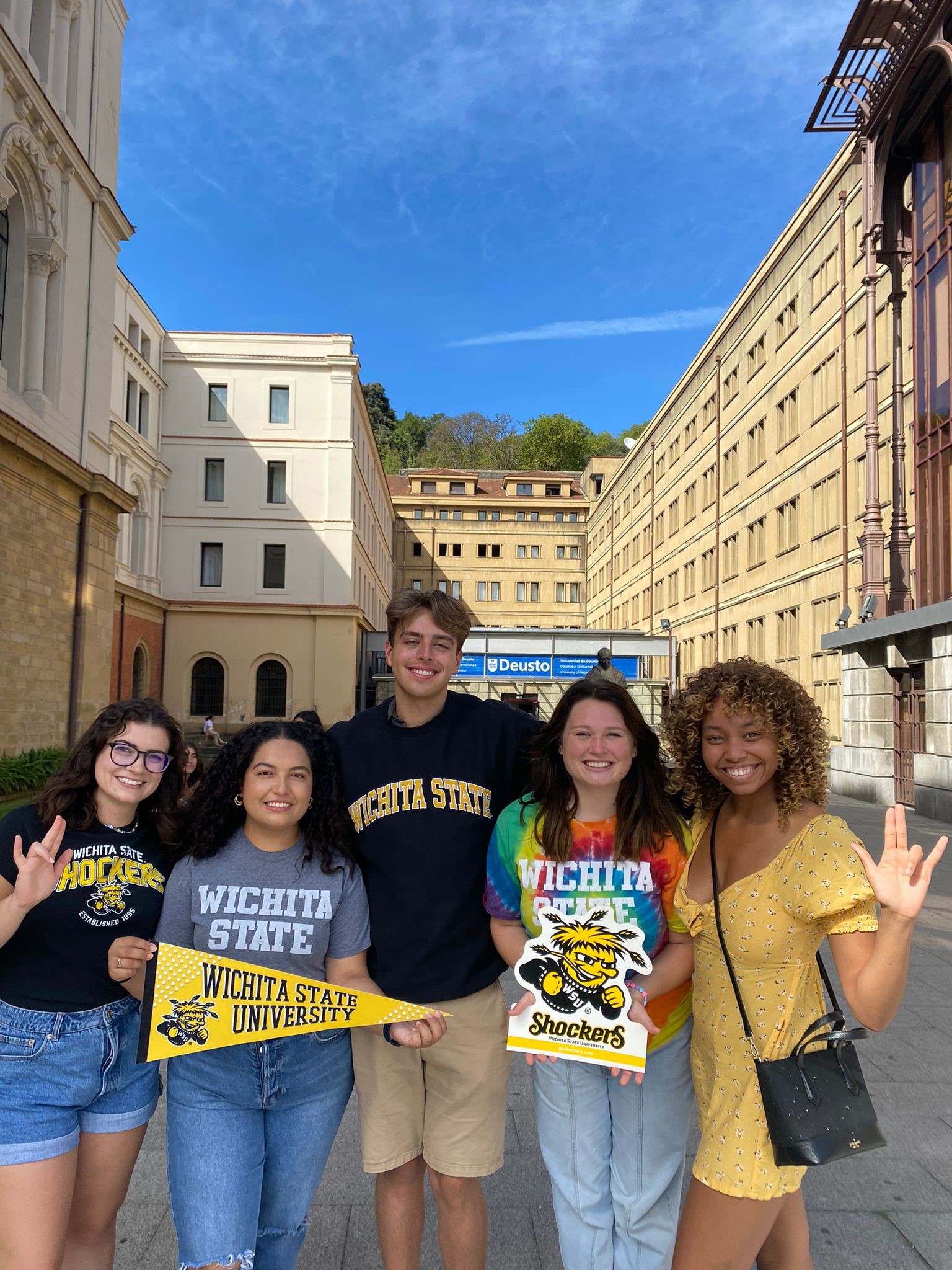Students with WSU Shocker signs in Spain