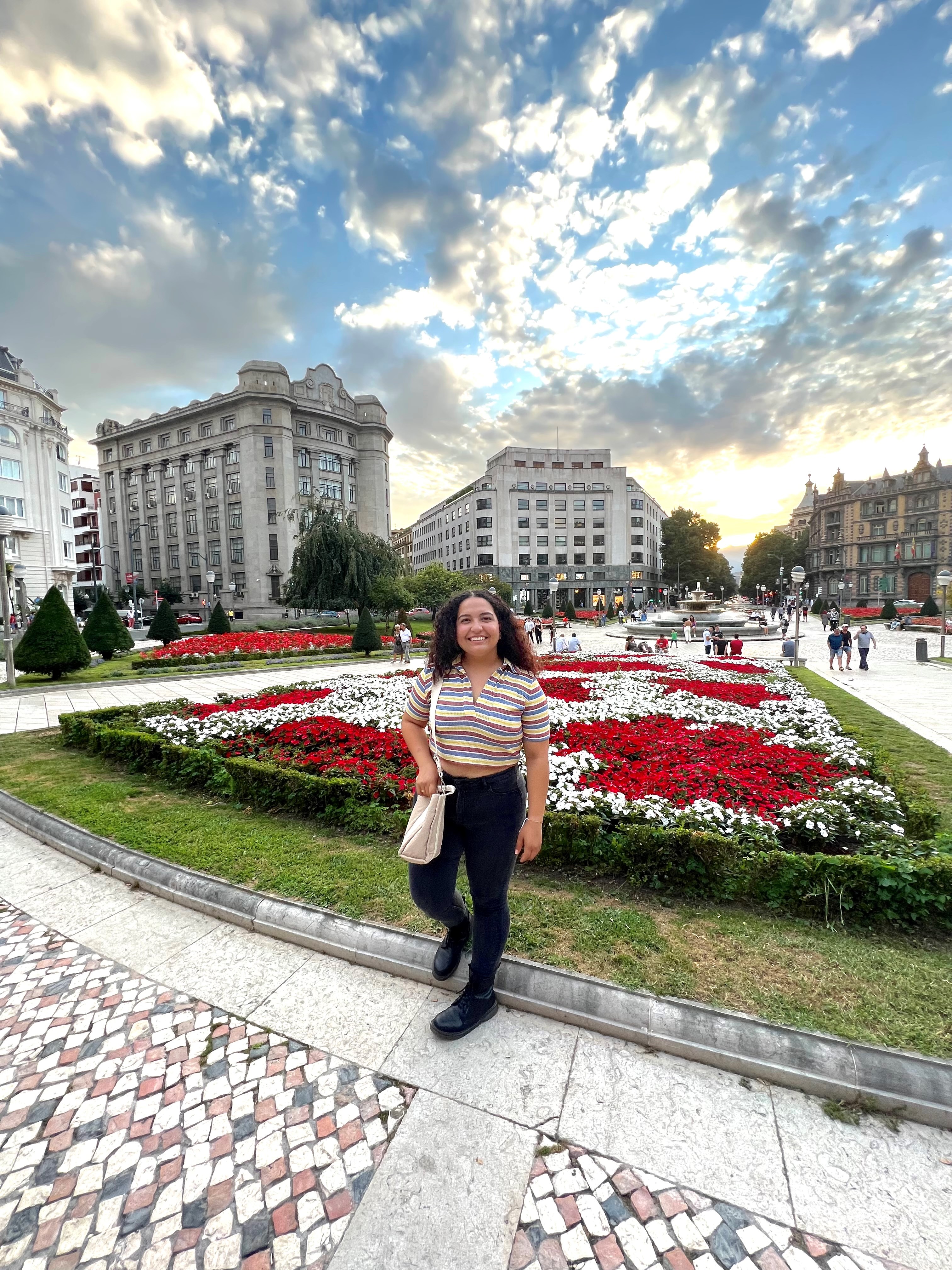 Student in front of garden
