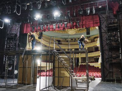 techs constructing theatre lighting on scaffolding