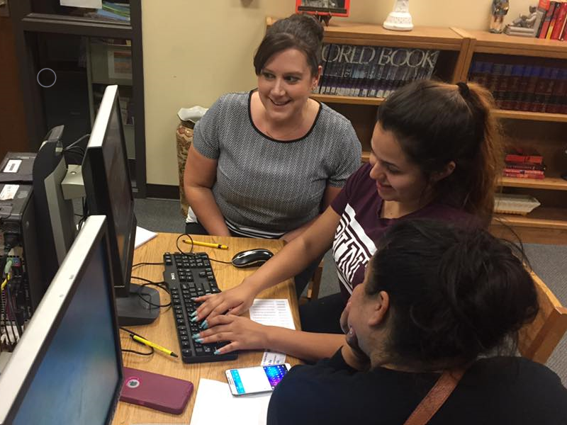 Advisor Tegan with family at computer