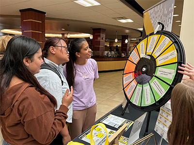 Students spinning a wheel at a workshop