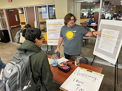 Student worker talking to a workshop attendee