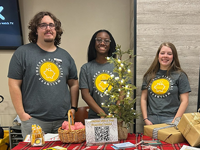 Student workers standing behind a table