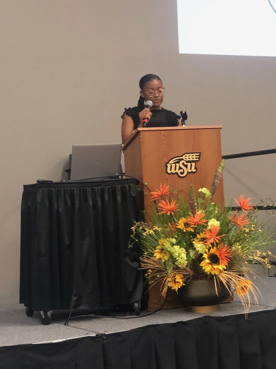 Photo of a student speaking at theansas Give Back 20th Anniversary Celebration