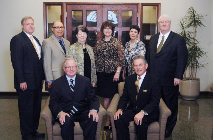 nine men and women in a group photo