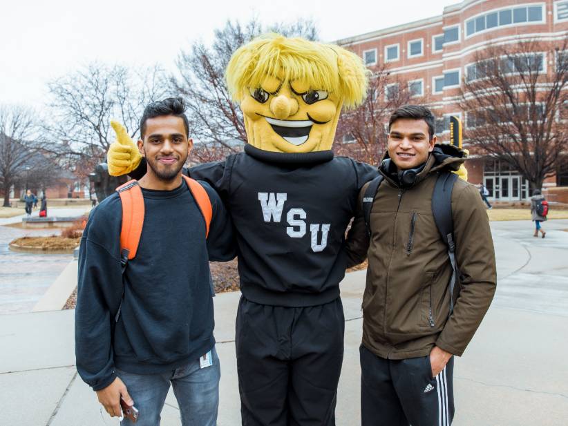 Wu posing with students