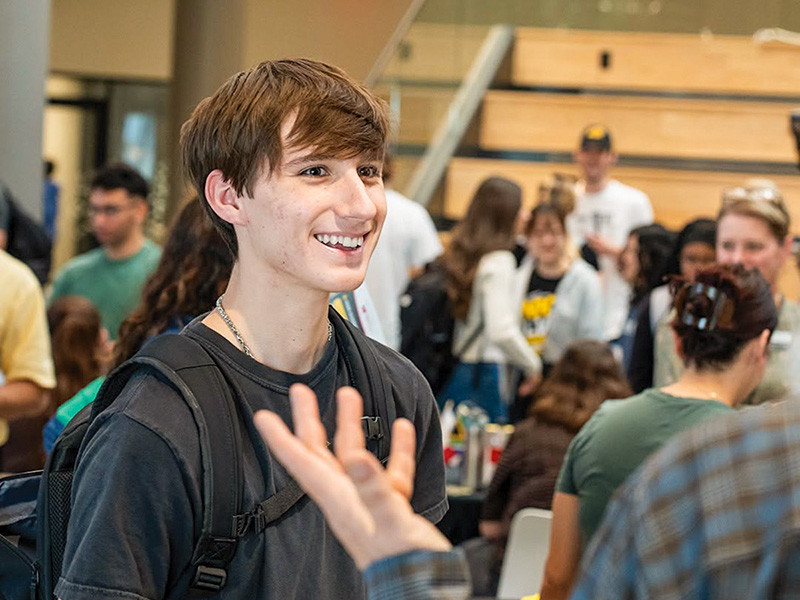 A student smiling at a school visit.