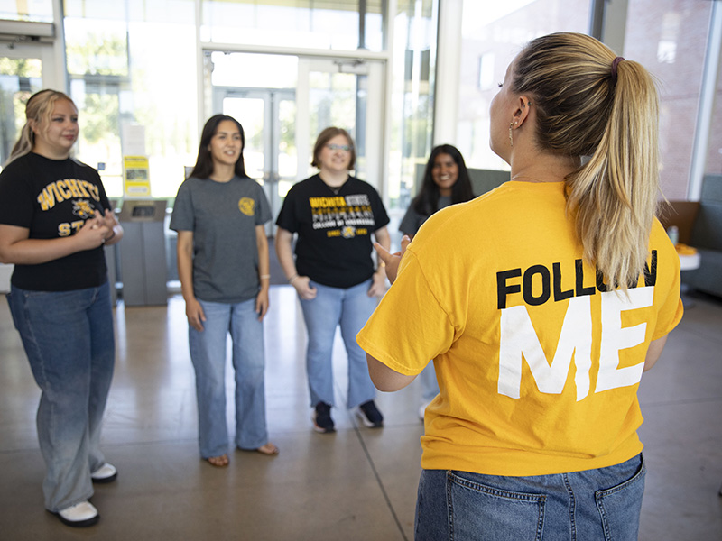 A guide leads a tour group on campus.