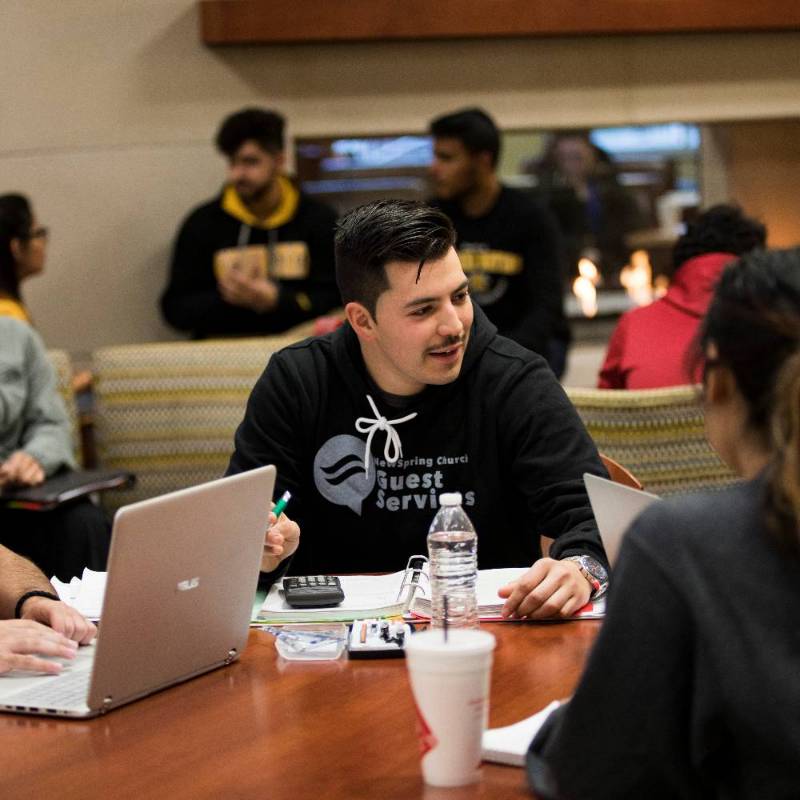 Group of students on laptops in the Rhatigan Student Center.