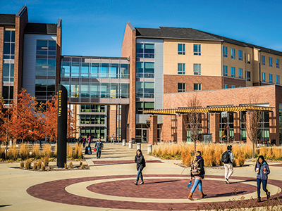 Students walk by Shocker Hall on a fall day