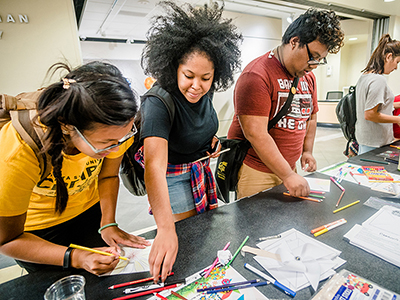 Students participating in a welcome table activity at the Rhatigan Student Center