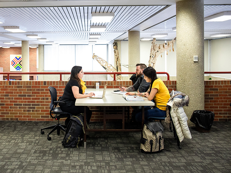 Adult learning students in library.