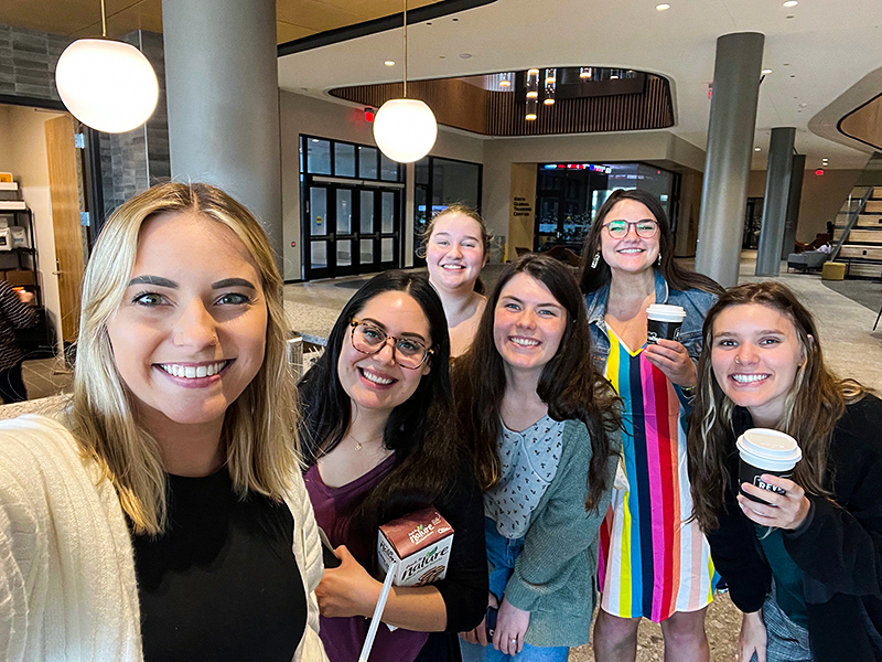Admissions staff members snap a selfie at the new Cargill Cafe.