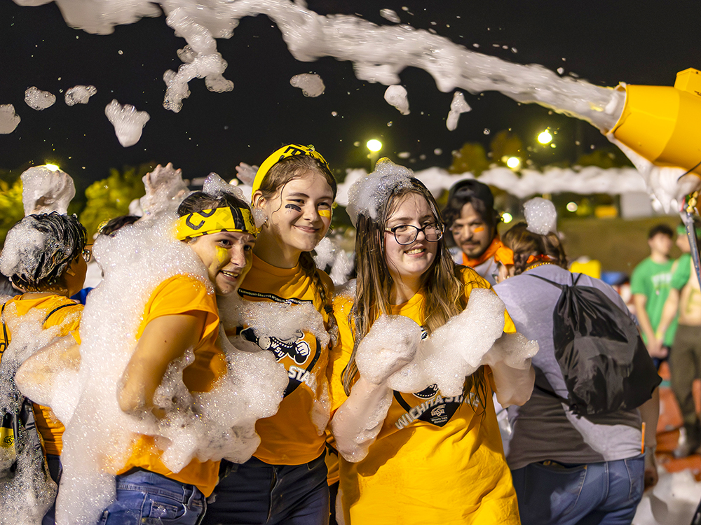 Students taking a photo during the foam party after Clash of Colleges.