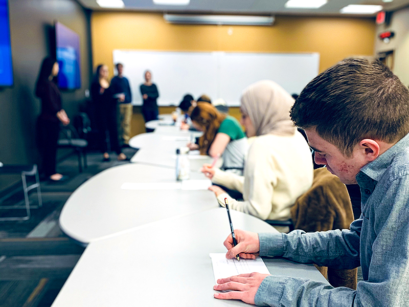 Students write during a class at Wichita State.