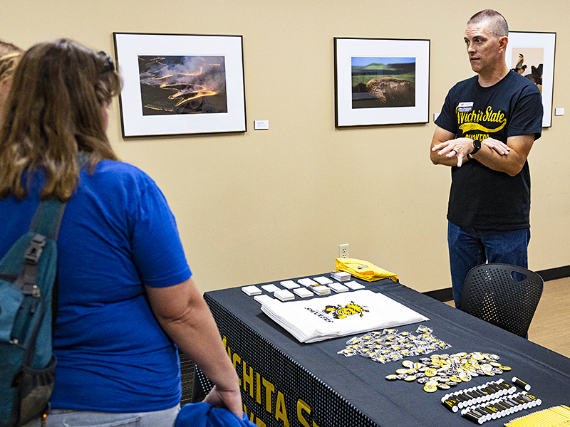 Chad Steinkamp, Director of Transfer and Adult Recruitment, talks with prospective students at the October 2022 Black and Yellow Day at Wichita State University.