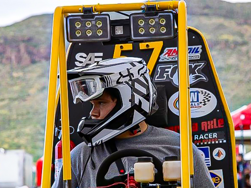 Cole McDaniel, chief engineer, behind the wheel of the Baja vehicle at competition.
