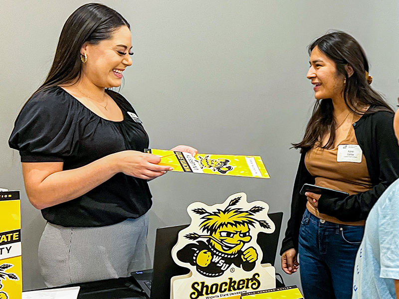 Elsie Hernandez, diversity recruiter, talks with students during an event.